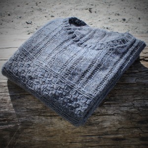 The Skye sweater sitting on driftwood